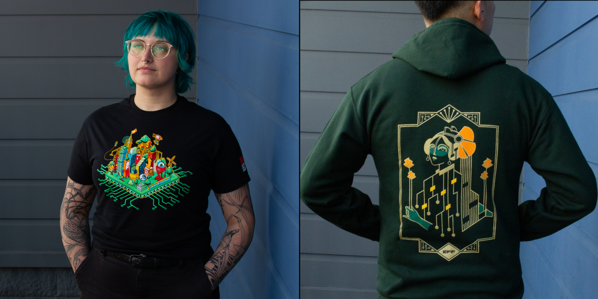 Person wearing a black shirt with the EFF35 Cityscape design next to a person wearing a green and gold Motherboard hoodie. Person wearing a black shirt with the EFF35 Cityscape design next to a person wearing a green and gold Motherboard hoodie.